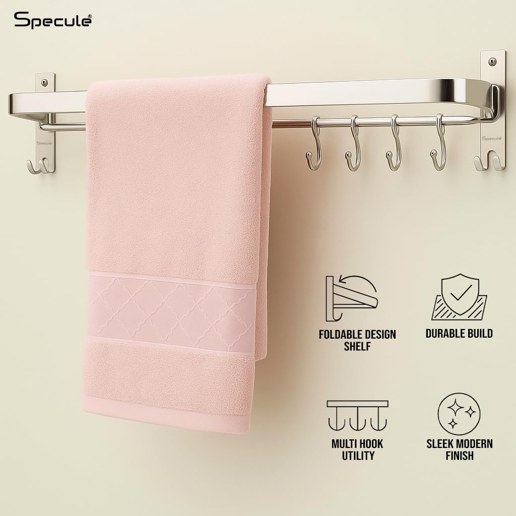 Wall-mounted foldable towel rod holding towels in a modern bathroom